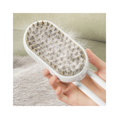 White steam brush held in a hand, its bristle pad packed with shed grey fur, beside a pet resting on a couch