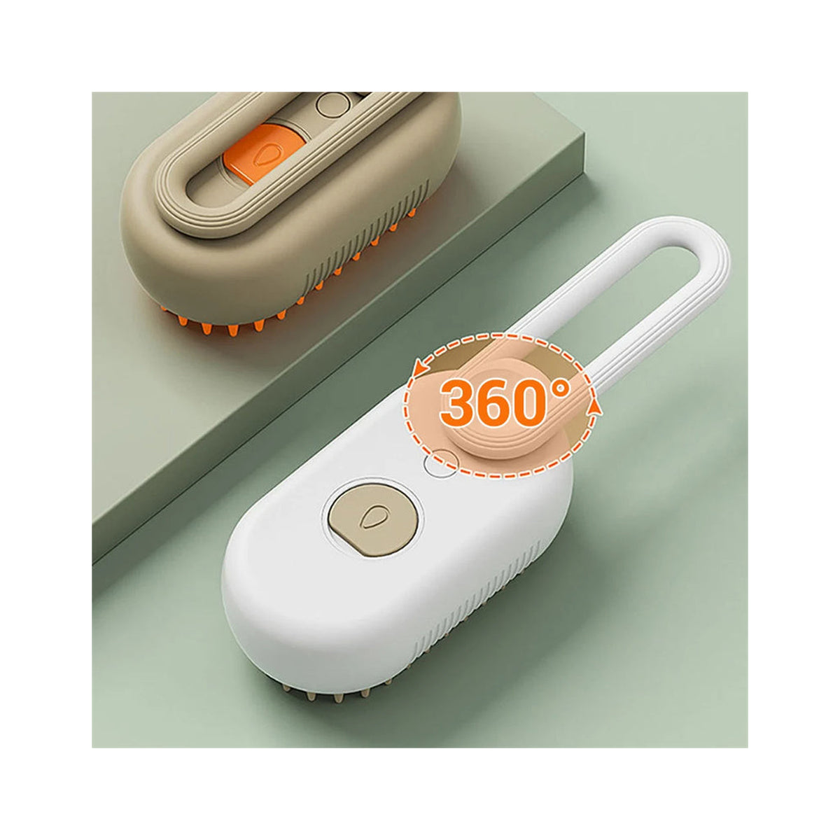 White loop-handle steam brush on a sage green surface with an orange rotation callout ringing its swivel handle, and a khaki brush with orange bristles behind