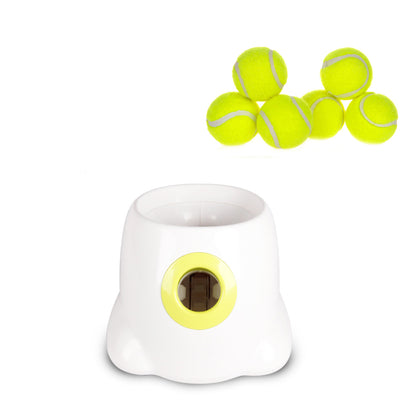 The white launcher on a plain white background with six yellow tennis balls arranged above it
