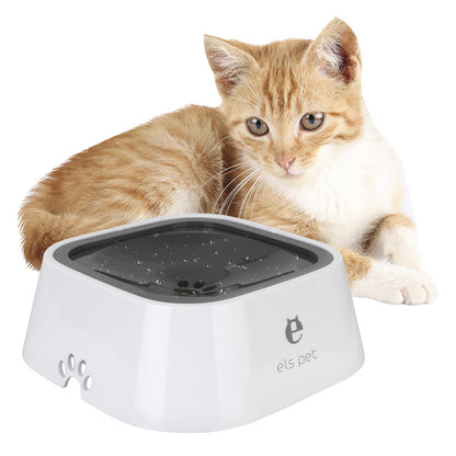 Ginger and white cat lying beside a white square water bowl with a dark grey inner plate