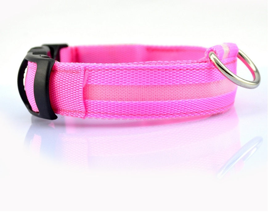 Close-up of a pink woven dog collar with a paler light strip, black slider and silver-coloured D-ring